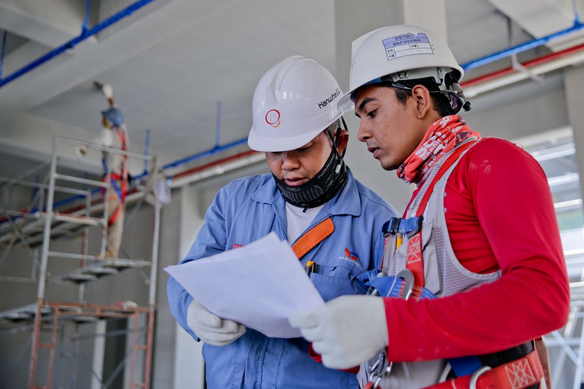 Pre-construction inspection with plans on site